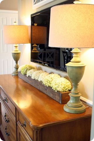 Long box of dried or faux hydrangeas under flat screen...so simple but so pretty. Could also work along a mantle or dresser