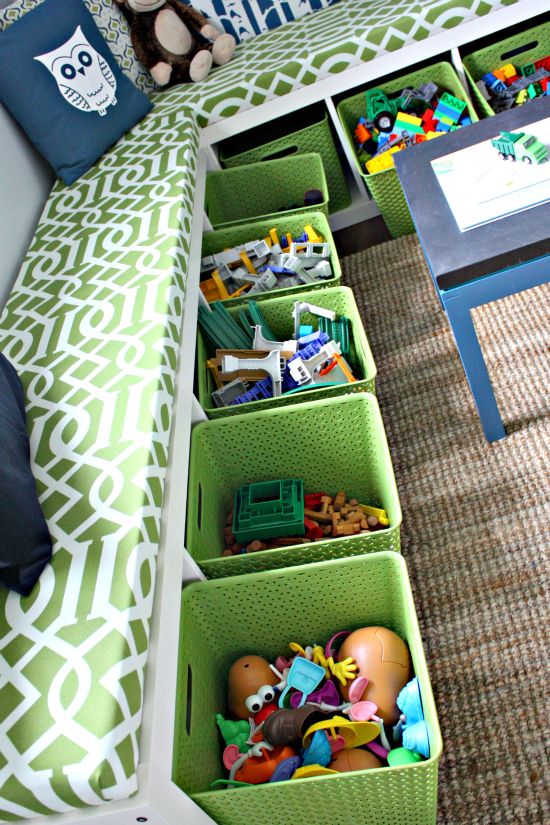Genius!! two tall skinny bookcases on their sides with fabric bins and custom cushions